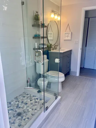 a bathroom with a sink a toilet and a mirror