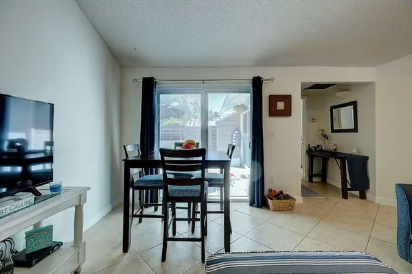 a view of a livingroom with furniture and a flat screen tv