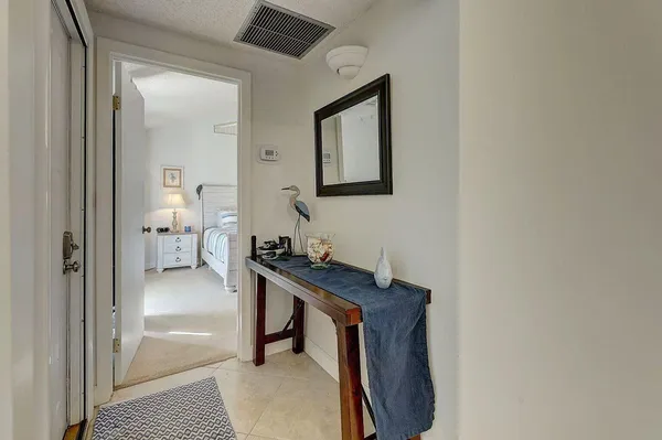 a hallway with a table and a bathroom