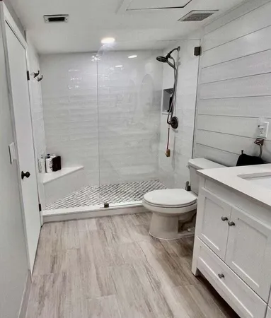 a bathroom with a sink a toilet and shower