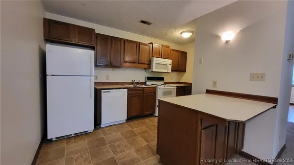 a kitchen with stainless steel appliances a refrigerator sink and microwave