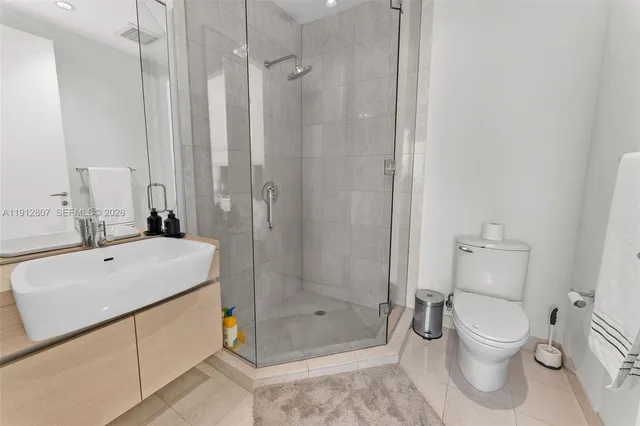 a large bedroom with a bed and a large window