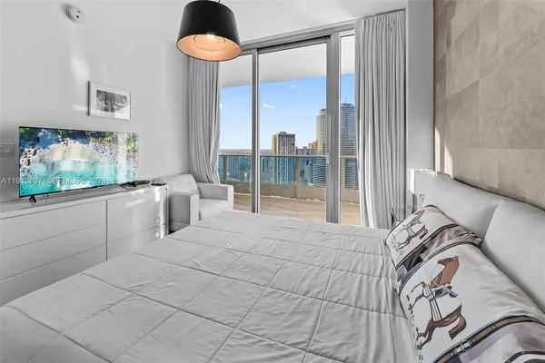 a bedroom with a bed and cabinets