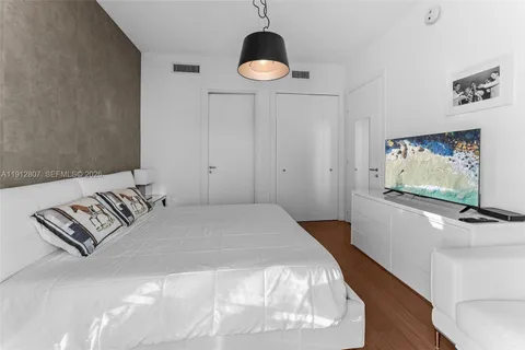 a bedroom with a bed and cabinets