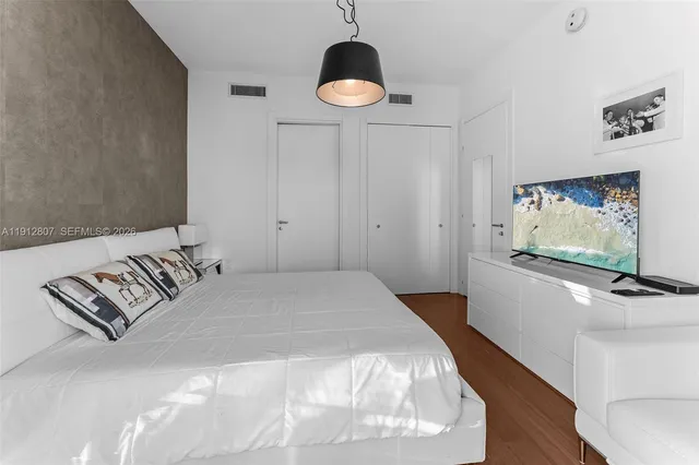 a bedroom with a bed and cabinets