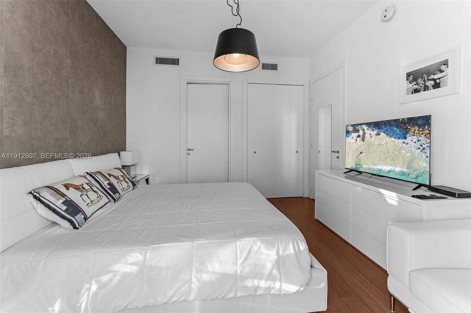 200 Biscayne Blvd Way, Unit 4510 Miami, FL 33131 - Photo 29 of 52 a bedroom with a bed and a flat screen tv