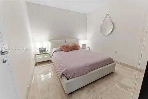 a bathroom with a sink a toilet and a wooden floor