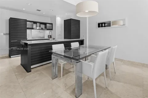 a kitchen with a table and chairs in it