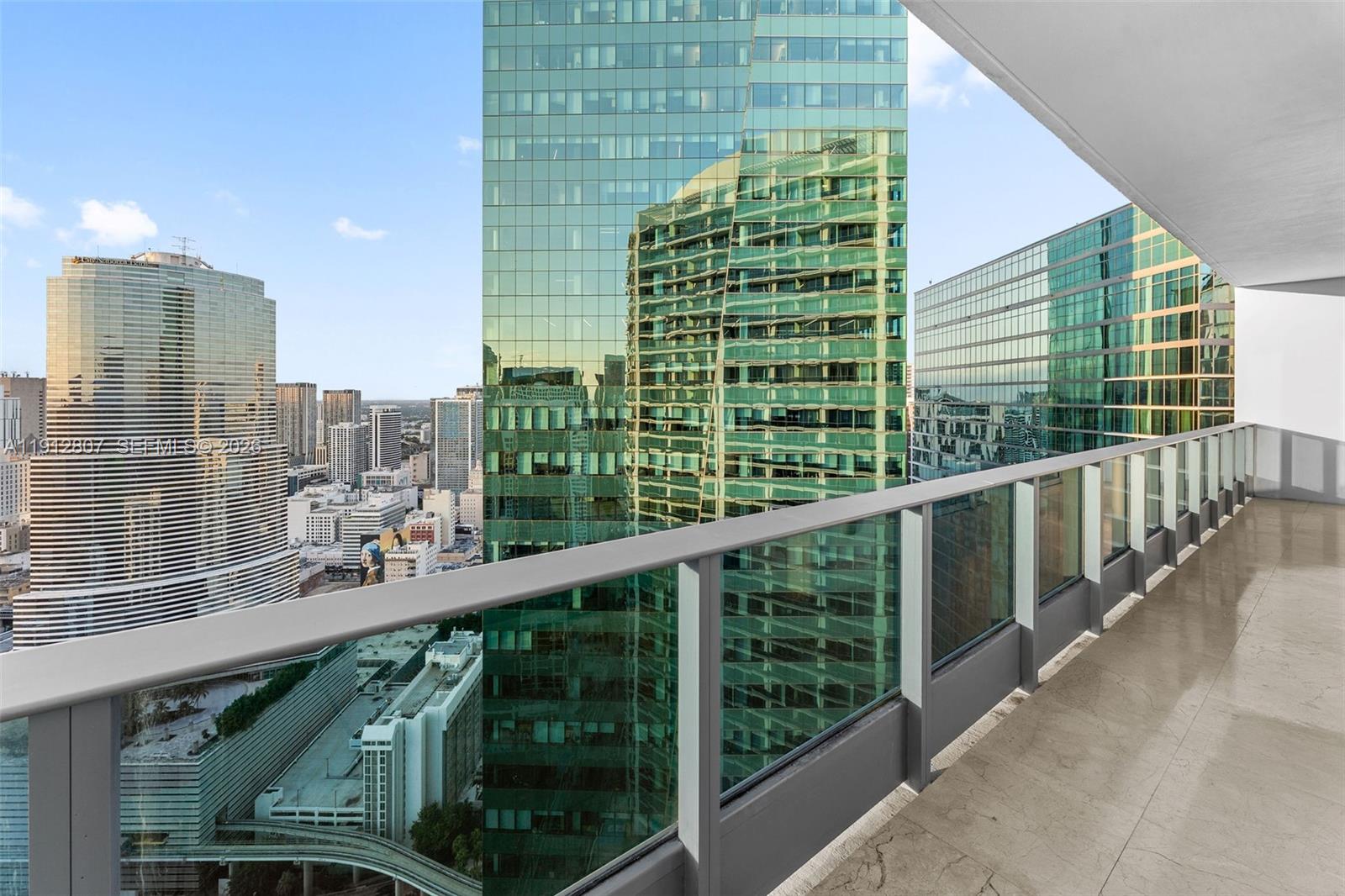 200 Biscayne Blvd Way, Unit 4510 Miami, FL 33131 - Photo 36 of 52 a view of a balcony with a floor to ceiling window and wooden floor