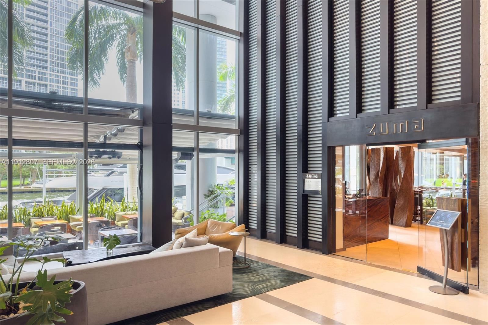 200 Biscayne Blvd Way, Unit 4510 Miami, FL 33131 - Photo 50 of 52 a living room with furniture and large windows