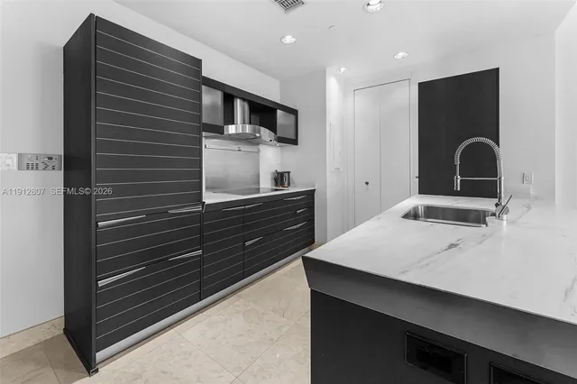 a kitchen with a sink and cabinets