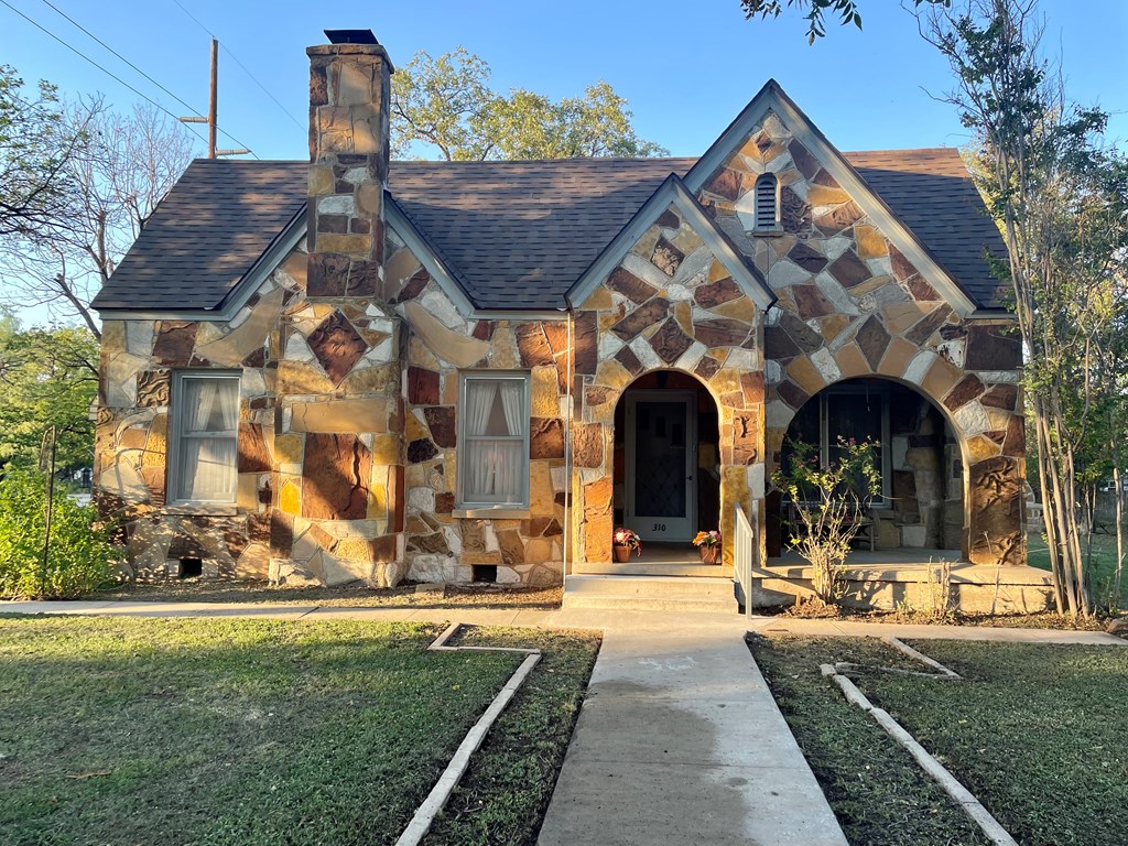 310 Canal Street Menard, TX 76859 - Photo 3 of 66 a front view of a house with garden