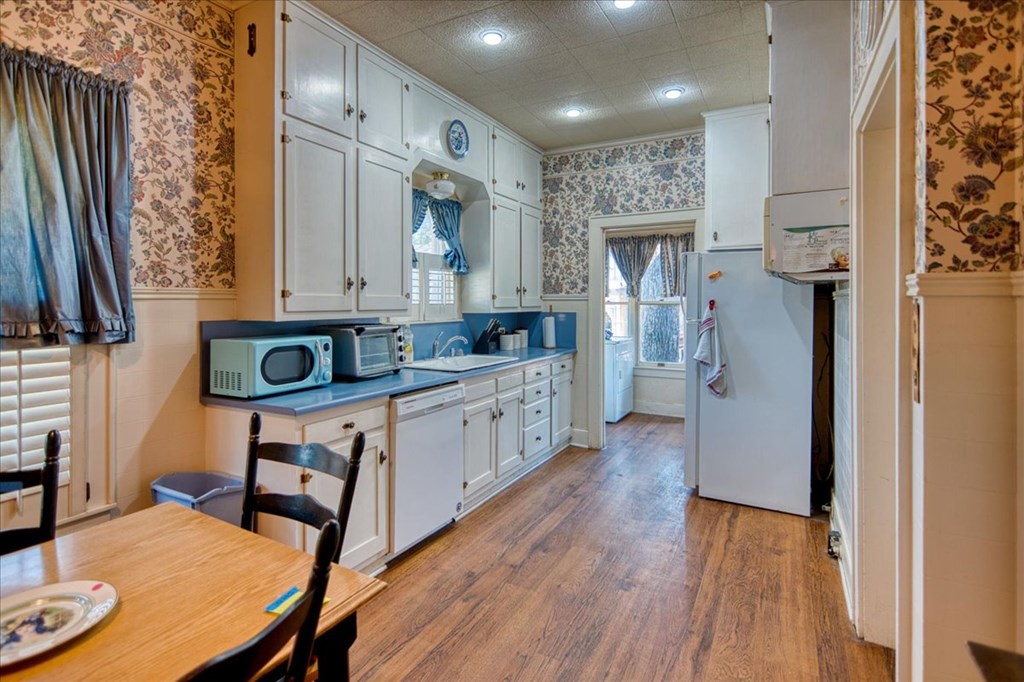 310 Canal Street Menard, TX 76859 - Photo 37 of 66 a kitchen with stainless steel appliances granite countertop a refrigerator a stove and a wooden floors