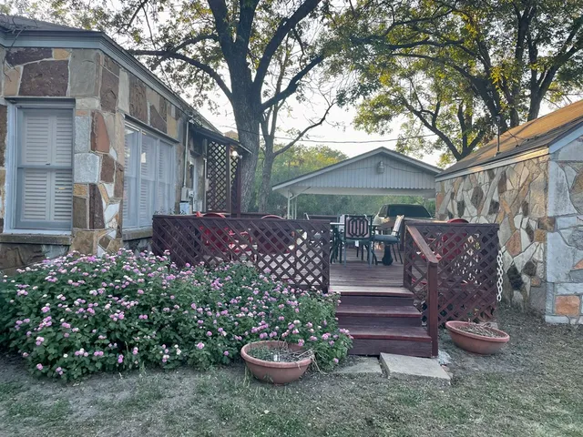 a large kitchen with stainless steel appliances a stove a sink dishwasher and cabinets