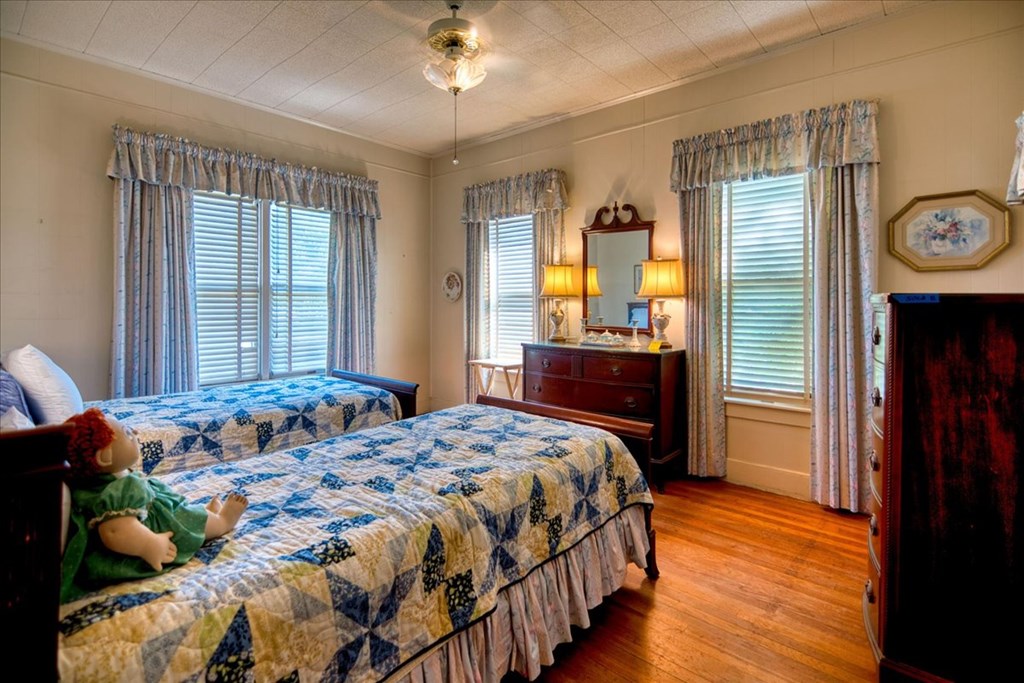 310 Canal Street Menard, TX 76859 - Photo 42 of 66 a bedroom with a bed and wooden floor