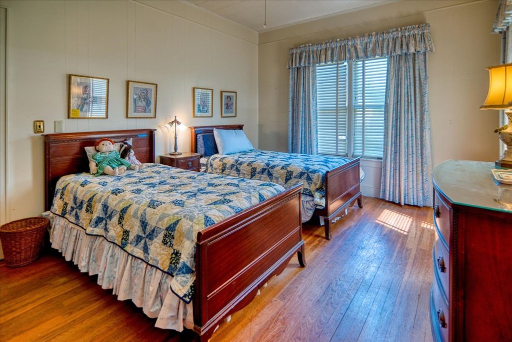 310 Canal Street Menard, TX 76859 - Photo 43 of 66 a bedroom with bed and wooden floor