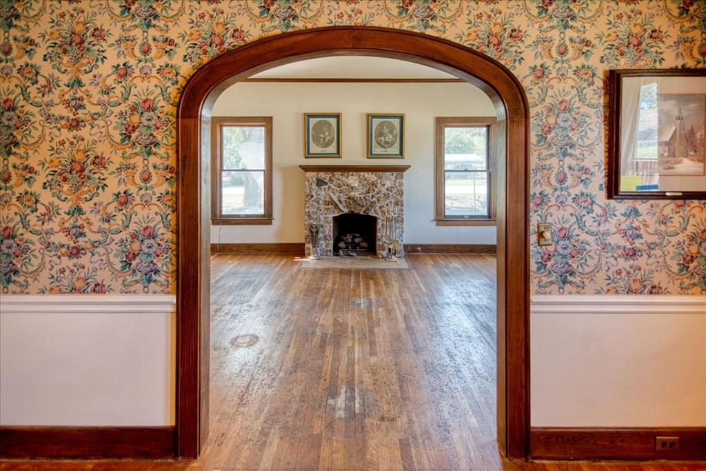 310 Canal Street Menard, TX 76859 - Photo 50 of 66 a view of a livingroom with wooden floor a fireplace and windows