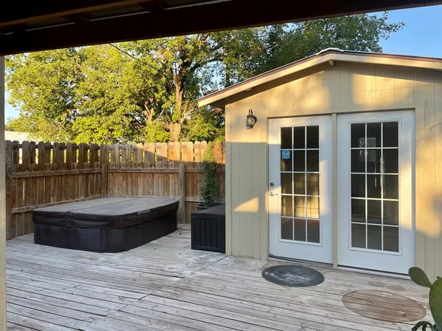 a bed room with a bed mirror and a chair