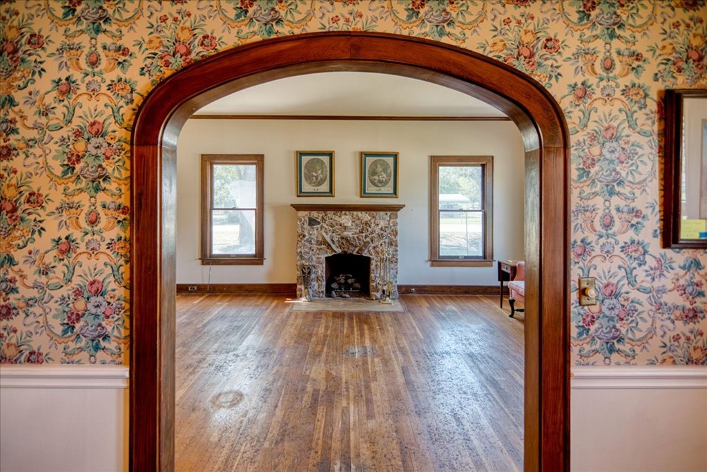 310 Canal Street Menard, TX 76859 - Photo 51 of 66 a view of a livingroom with wooden floor a fireplace and windows
