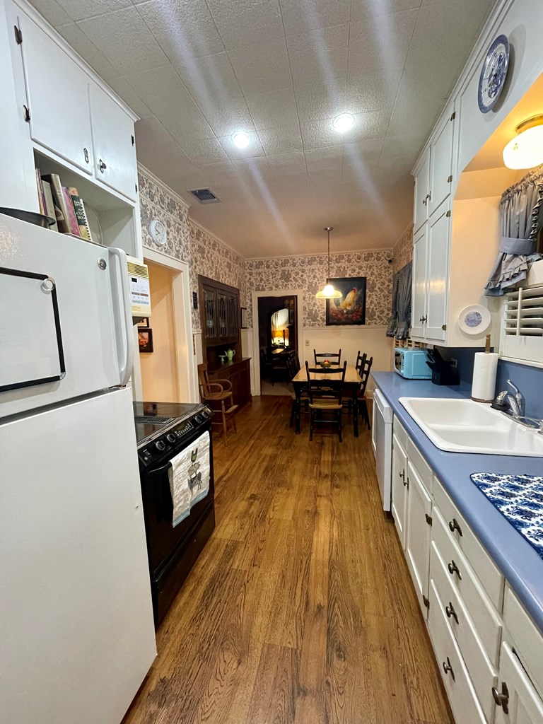 310 Canal Street Menard, TX 76859 - Photo 6 of 66 a large kitchen with stainless steel appliances a stove a sink dishwasher and cabinets