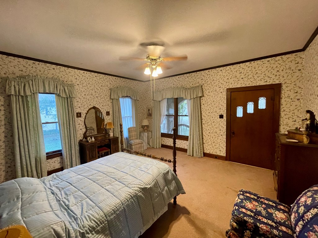 310 Canal Street Menard, TX 76859 - Photo 7 of 66 a bed room with a bed mirror and a chair