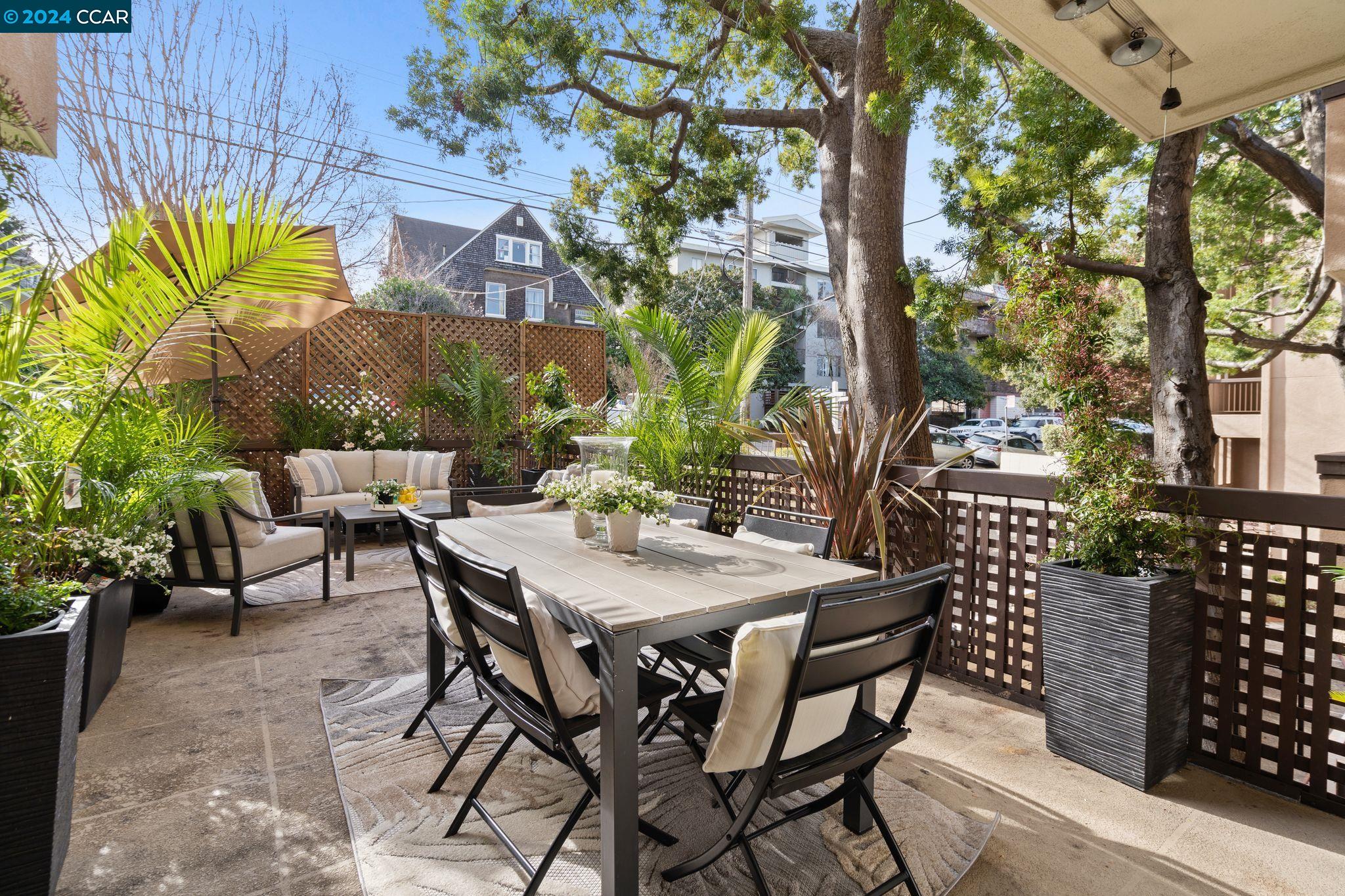 a view of a patio with table and chairs and potted plants