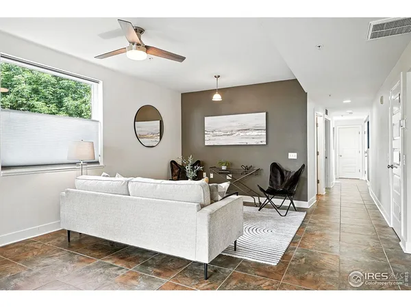 a living room with furniture and a large window