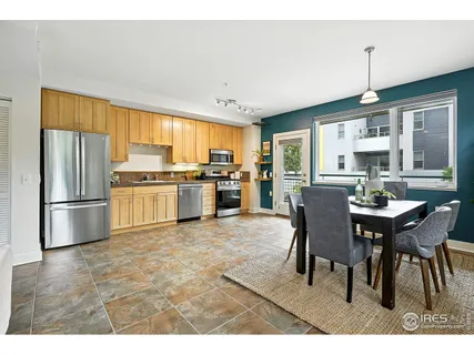 a kitchen with refrigerator cabinets dining table and chairs
