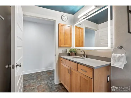 a bathroom with a sink vanity and mirror