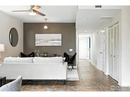 a living room with furniture a large window and a projector