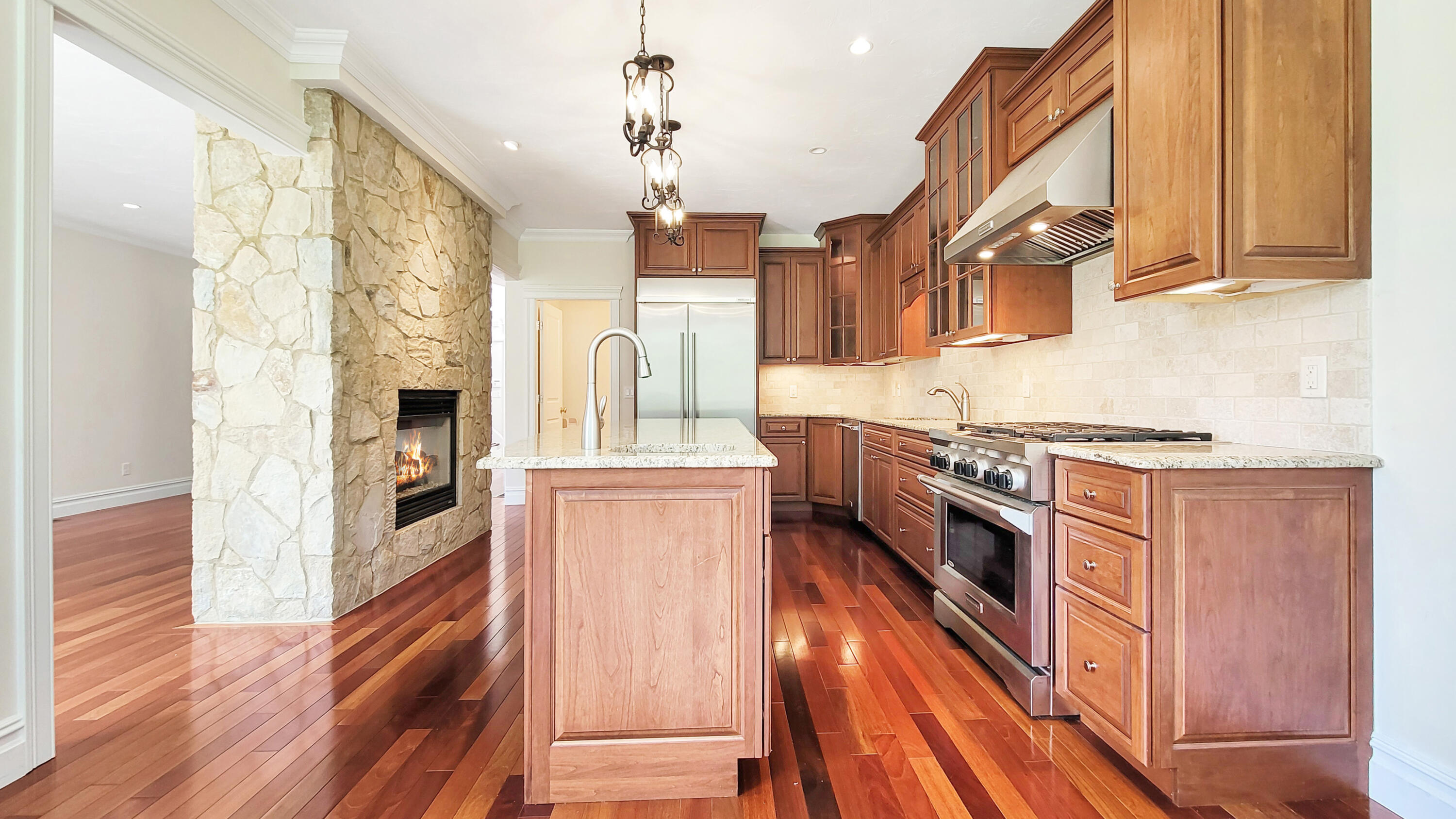 4 Quinns Way Mashpee, MA 02649 - Photo 12 of 28 a kitchen with stainless steel appliances granite countertop a refrigerator a stove and a wooden floors