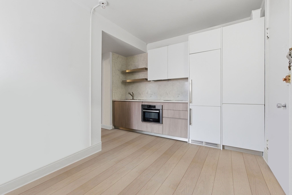 21 Beacon Street, Unit 11L Boston, MA 02108 - Photo 2 of 23 a view of a kitchen with a sink and a refrigerator