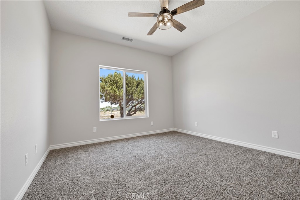 14586 Ash Hesperia, CA 92345 - Photo 16 of 30 a view of room with window and ceiling fan