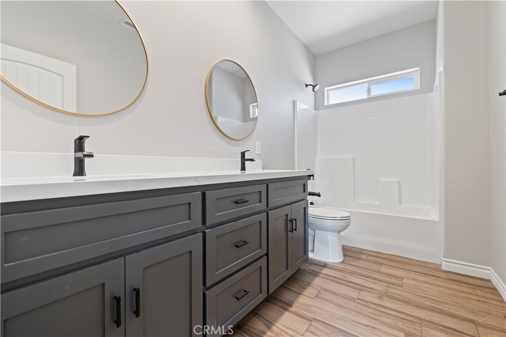 14586 Ash Hesperia, CA 92345 - Photo 19 of 30 a bathroom with a double vanity sink mirror and toilet