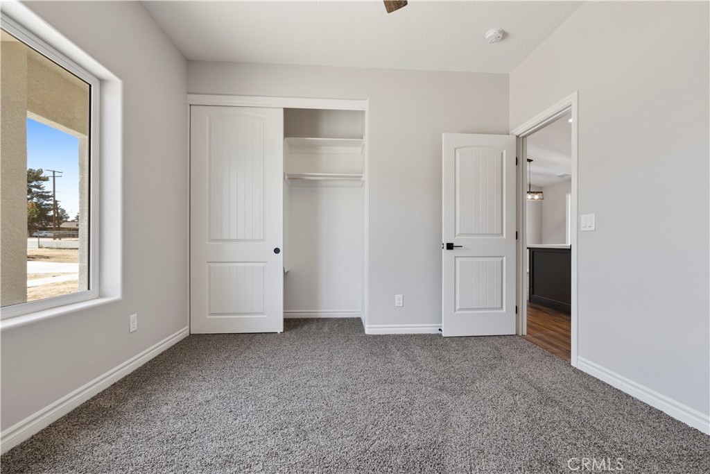 14586 Ash Hesperia, CA 92345 - Photo 21 of 30 an empty room with windows and closet