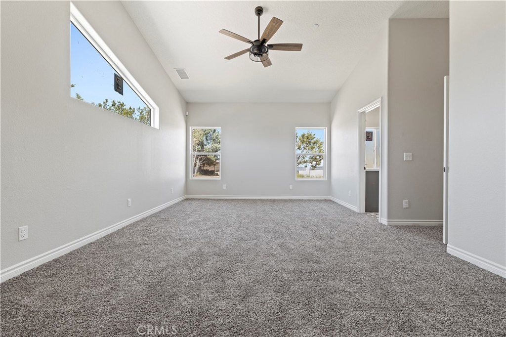 14586 Ash Hesperia, CA 92345 - Photo 23 of 30 an empty room with windows and fan