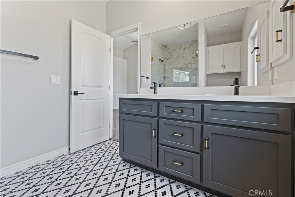 14586 Ash Hesperia, CA 92345 - Photo 25 of 30 a spacious bathroom with a sink a mirror and a bathtub
