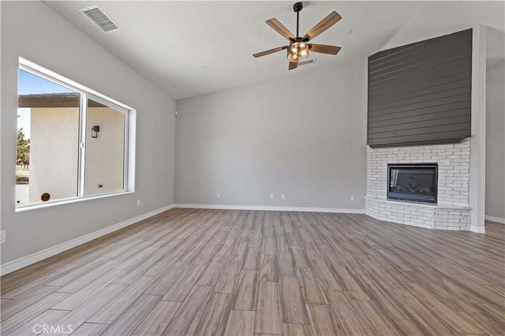 14586 Ash Hesperia, CA 92345 - Photo 5 of 30 a view of empty room with wooden floor and fireplace
