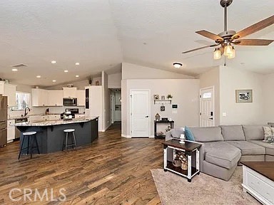 14586 Ash Hesperia, CA 92345 - Photo 9 of 30 a living room with stainless steel appliances kitchen island granite countertop furniture and a view of kitchen
