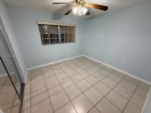 a view of an empty room with windows