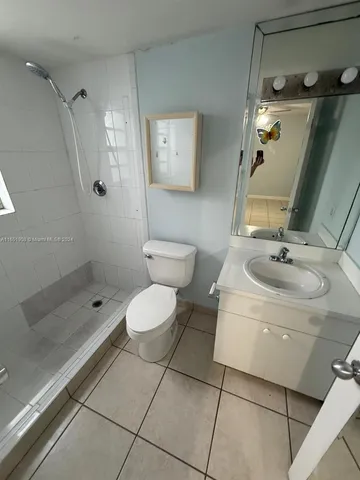 a bathroom with a toilet sink and shower