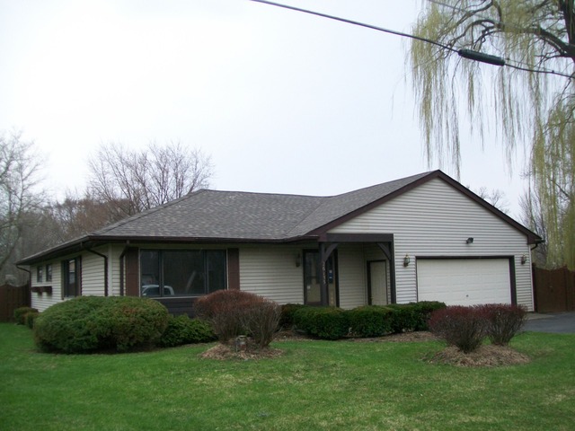 26155 West Lotus Road Antioch, IL 60002 - Photo 1 of 14 a view of a house with a yard plants and large tree