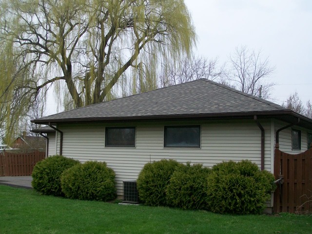 26155 West Lotus Road Antioch, IL 60002 - Photo 2 of 14 a front view of a house with a garden