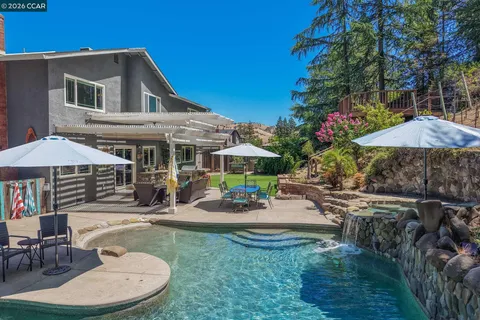 an outdoor space with patio and white umbrellas