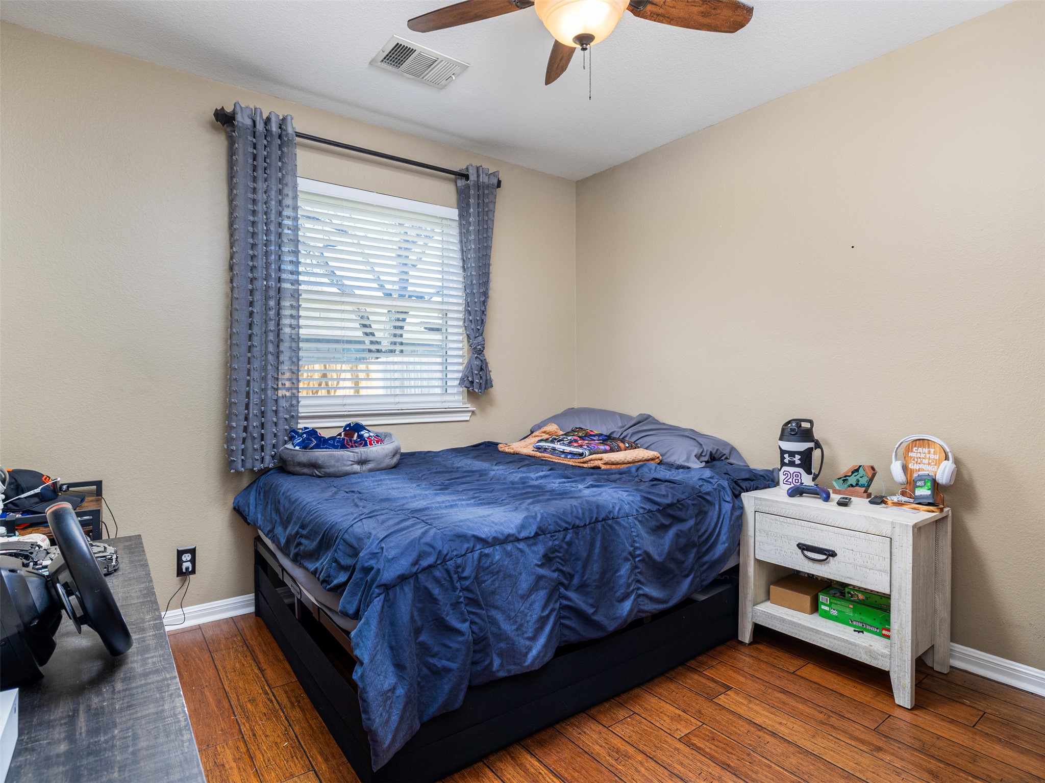 208 South Buffalo Pass Georgetown, TX 78633 - Photo 17 of 28 Bedroom with dark wood finished floors and ceiling fan