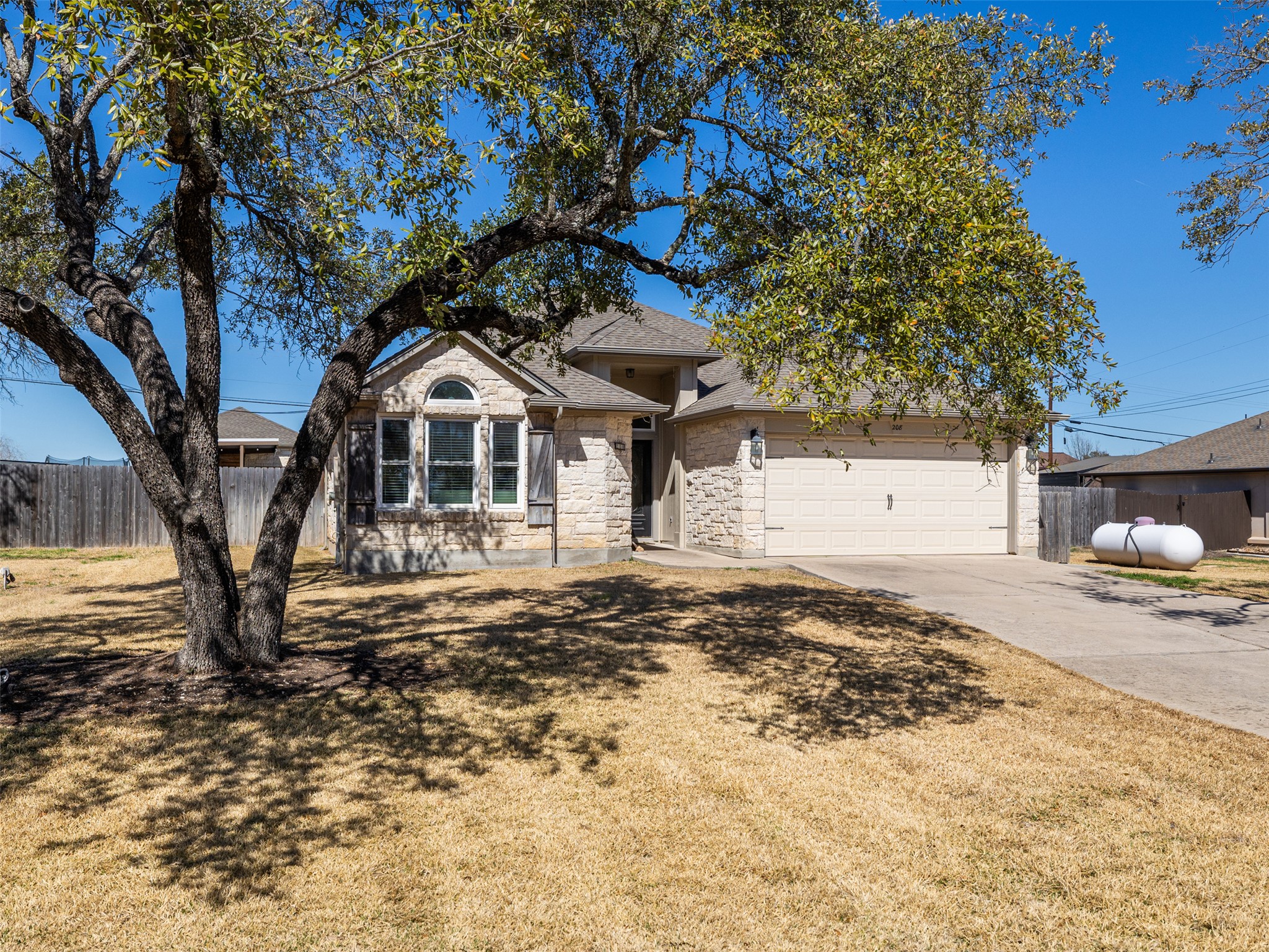 208 South Buffalo Pass Georgetown, TX 78633 - Photo 2 of 28 Single story home featuring driveway, a garage, and brick siding
