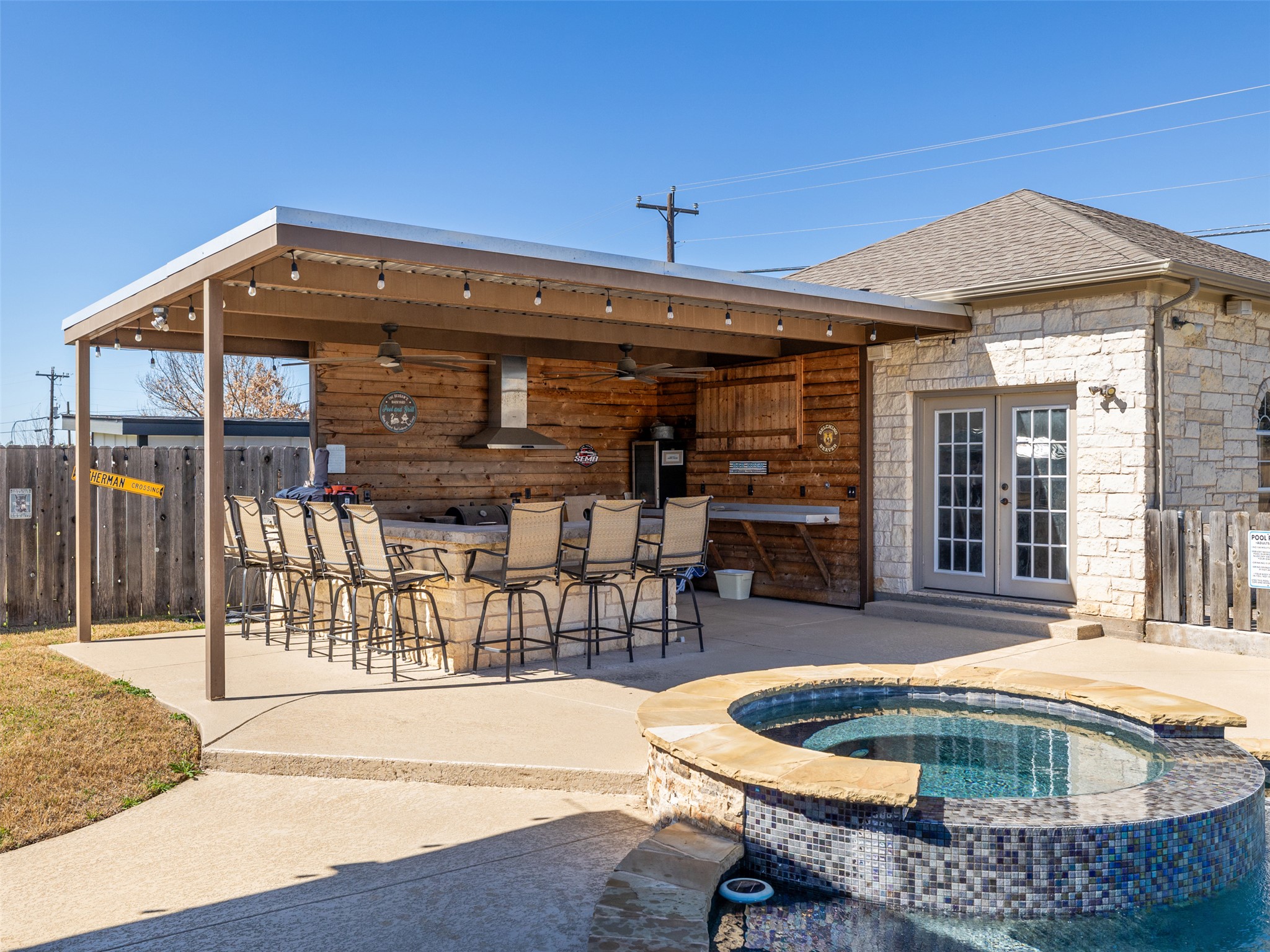 208 South Buffalo Pass Georgetown, TX 78633 - Photo 20 of 28 Outdoor kitchen area with TV and seating.