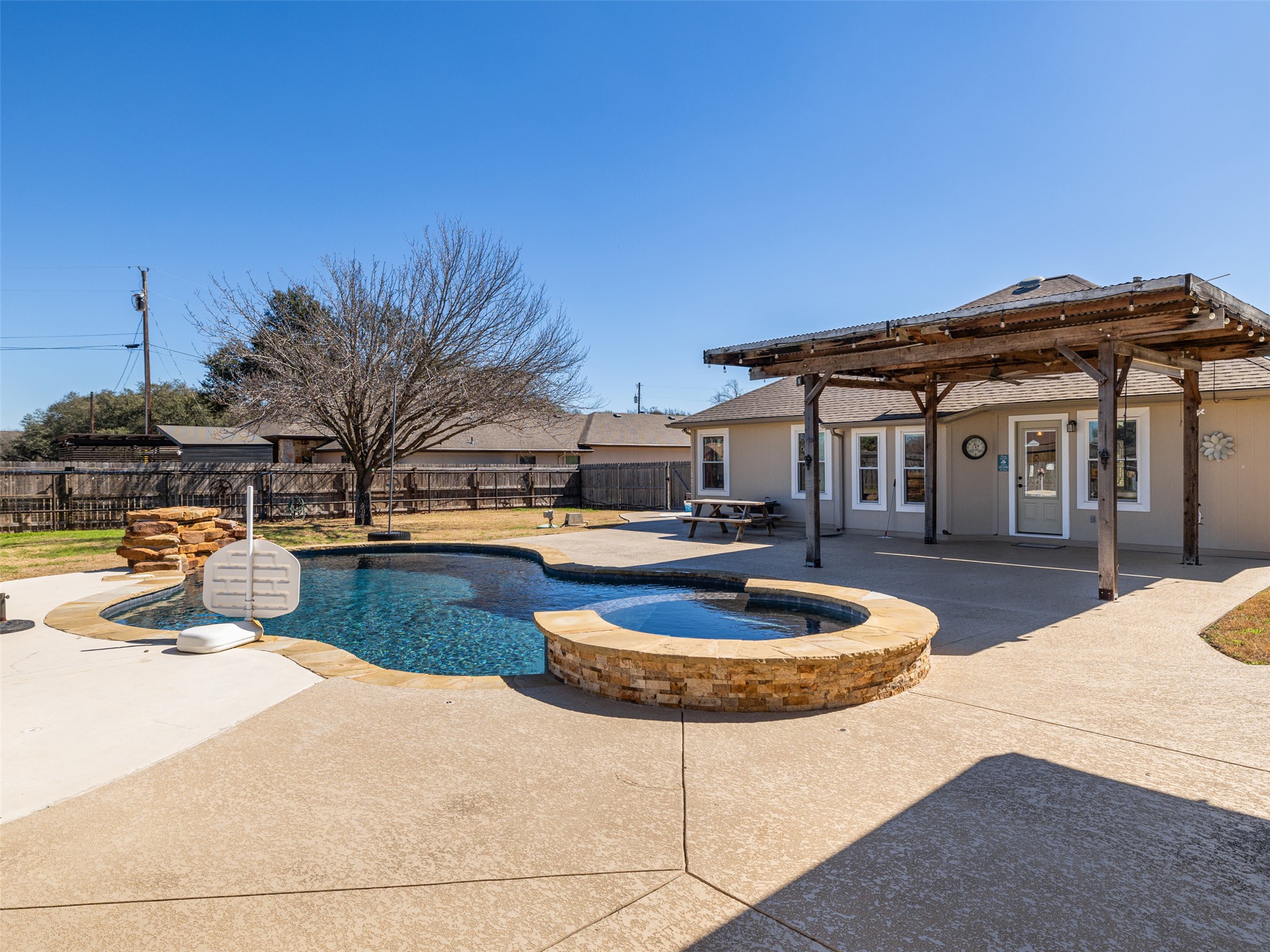 208 South Buffalo Pass Georgetown, TX 78633 - Photo 22 of 28 Combined pool / hot tub with a pergola, a patio area, a fenced backyard, and french doors