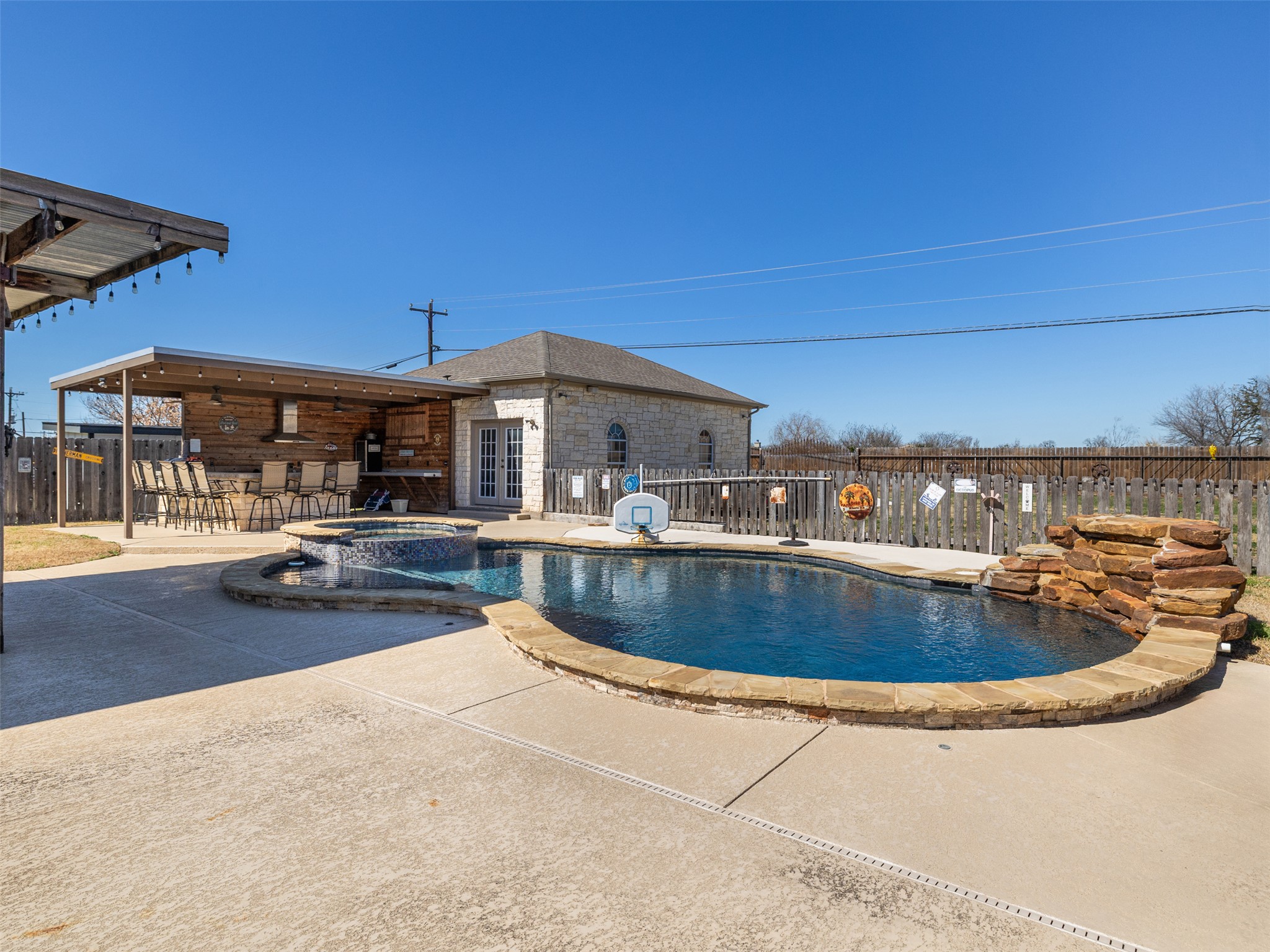 208 South Buffalo Pass Georgetown, TX 78633 - Photo 23 of 28 Relaxing pool / spa with a fenced backyard, a patio area, and an outdoor bar