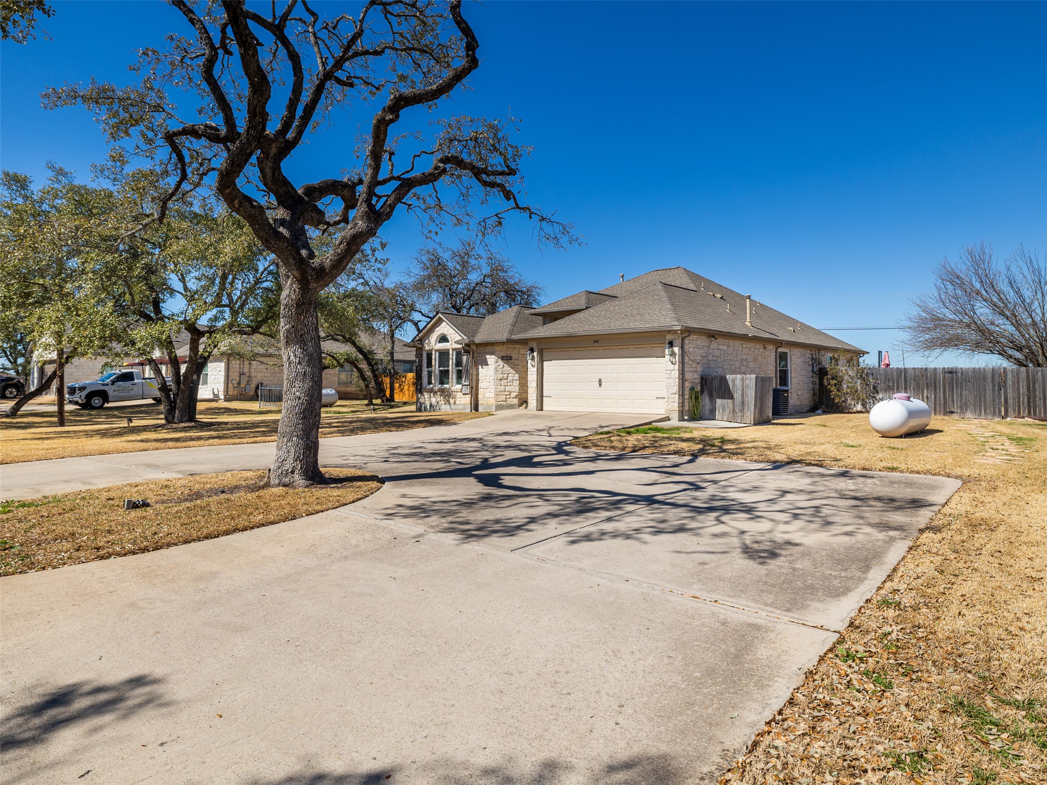 208 South Buffalo Pass Georgetown, TX 78633 - Photo 3 of 28 View of front facade featuring brick siding, an attached garage, and concrete driveway
